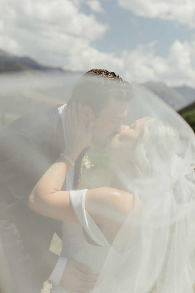 A bride and groom kiss at the Valley Floor in Telluride, Colorado.