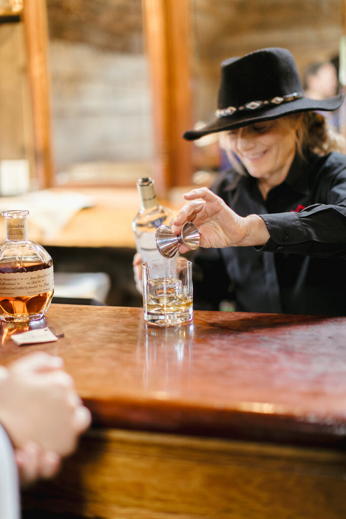 A bartender pours a shot of whiskey in the saloon at Gorrono Ranch in Telluride, Colorado.