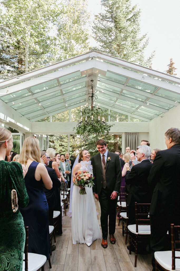Couple recesses down the aisle at Sonnenalp Vail in Eagle County, Colorado.