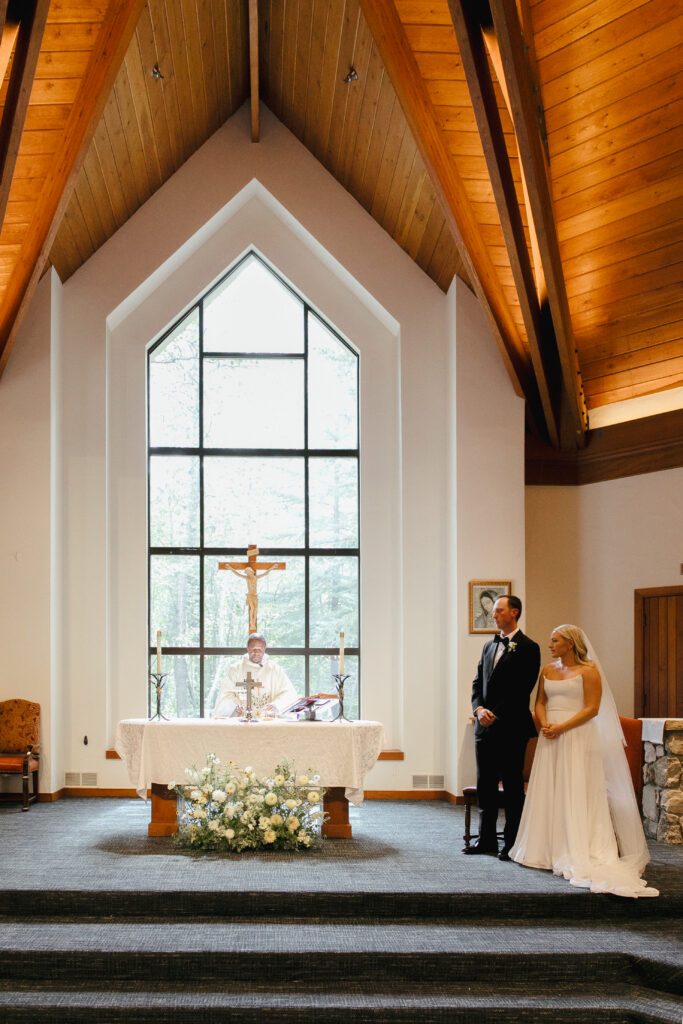 Couple stands at the altar inside the Chapel at Beaver Creek