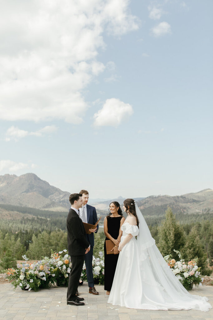 Couple stands with officiants at the top of the Pikes Peak Ranch wedding ceremony site.
