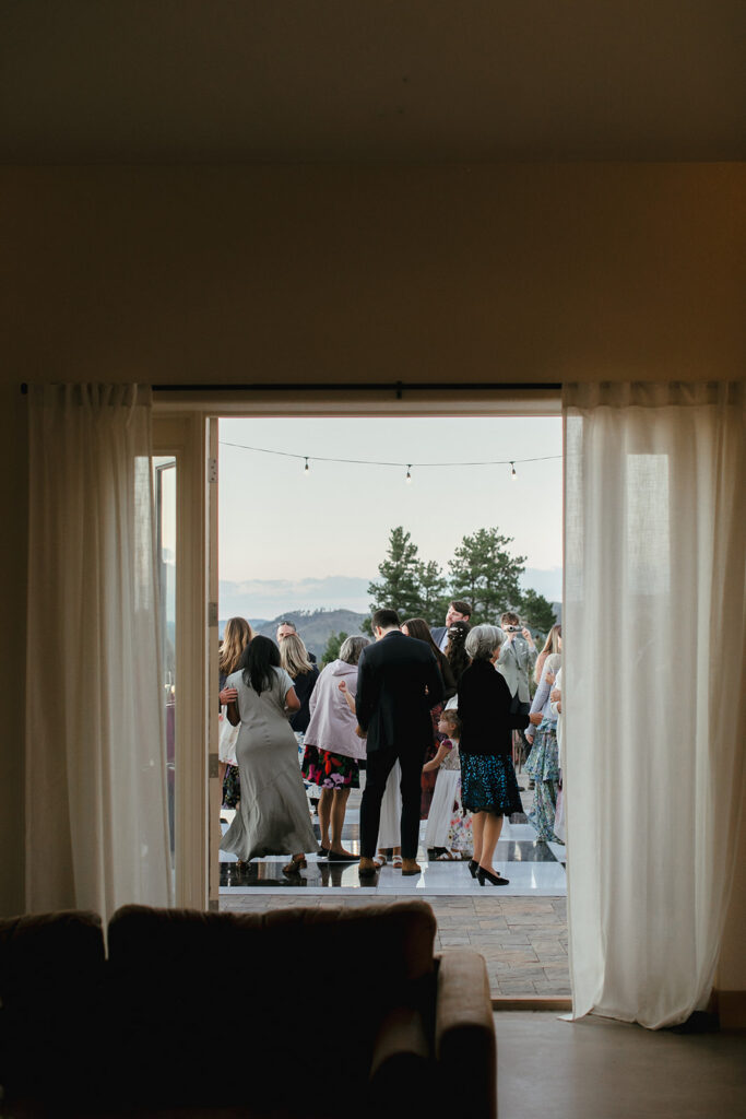 Guests dance on checkboard dance floor on patio at Pikes Peak Ranch in Woodland Park, Colorodo.