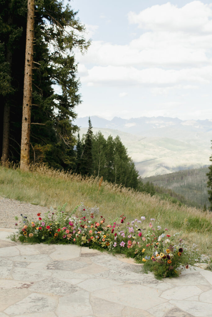 Floral ground arch at Beaver Creek wedding deck ceremony setup
